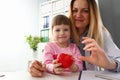 Little baby girl visiting doctor holding in hands red toy heart Royalty Free Stock Photo