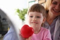 Little baby girl visiting doctor holding in hands red toy heart Royalty Free Stock Photo