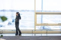 little baby girl waiting boarding to her flight in airport transit hall and looking at airplane parking near departure Royalty Free Stock Photo