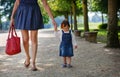 Little baby girl walking with beautiful mother in summer park Royalty Free Stock Photo