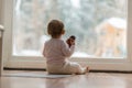 Little baby girl watching the snow outdoors Royalty Free Stock Photo