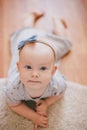 Little baby girl wearing bow crawling on a floor Royalty Free Stock Photo