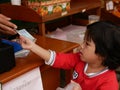 Little baby girl, 3 years old, learning to buy stuff and receive the change by herself - children development by allowing them to Royalty Free Stock Photo