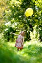 Little baby girl with a yellow balloon Royalty Free Stock Photo