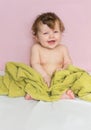 Little baby in a green towel after bathing. Royalty Free Stock Photo