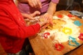 Mother and her little baby making hands cookies at home in the kitchen Royalty Free Stock Photo