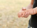 Little baby hand with father`s hand on light background with copy space, family and childhood concept Royalty Free Stock Photo