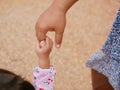 Little baby hand holding on her mother`s hand representing mother-child bond and relationship