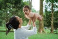 Little baby is happy when his mother lift him up