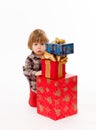 Little baby hiding behind presents