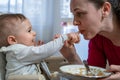 Little baby and his mother feed each other. Royalty Free Stock Photo