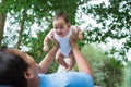 Little baby laughs when his father lift