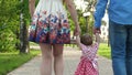 Little baby learning how to walk with mom and dad,happy family walking in summer Park Royalty Free Stock Photo