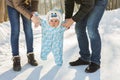 Little baby learning to walk. Mother and father with toddler boy at the winter park Royalty Free Stock Photo