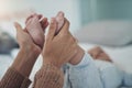 Little baby, lots of love. an unrecognisable woman holding her babys feet on the bed at home. Royalty Free Stock Photo