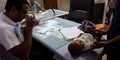 Little baby lying on doctors table for checkup