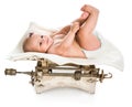 Little baby lying on retro scales Royalty Free Stock Photo
