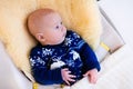 Little baby in nordic sweater on sheepskin Royalty Free Stock Photo