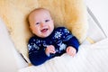 Little baby in nordic sweater on sheepskin Royalty Free Stock Photo