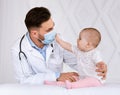 Little Baby Patient Touching Doctor`s Face Mask During Appointment Indoor Royalty Free Stock Photo