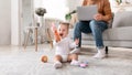 Little Baby Playing While Father Working On Laptop At Home Royalty Free Stock Photo