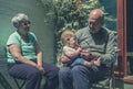 Grandparents in yard with baby Royalty Free Stock Photo