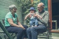 Grandparents in yard with baby Royalty Free Stock Photo