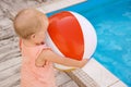 Little baby playing near swimming pool. Dangerous situation Royalty Free Stock Photo