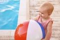 Little baby playing near outdoor swimming pool Royalty Free Stock Photo