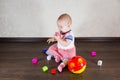 Little baby playing with toys. Small child chews on a toy