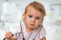 Little baby plays doctor with stethoscope