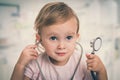 Little baby plays doctor with stethoscope Royalty Free Stock Photo