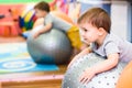 Little baby plays with a fitball in the gym Royalty Free Stock Photo