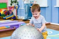 Little baby plays with a fitball in the gym Royalty Free Stock Photo