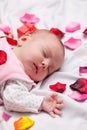 Little baby with rose petals Royalty Free Stock Photo