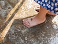 Little baby`s bare feet on wet ground, sand - letting your baby play in dirt could boost the child`s immune system Royalty Free Stock Photo