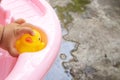 Hand caught the yellow duck while bathing