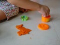 Little baby`s hands collecting and putting playdough back into the box, after finish playing Royalty Free Stock Photo