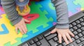 Little baby`s hands, on a computer mouse and keyboard - child development, getting familiar with technology since their early age Royalty Free Stock Photo