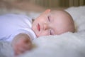 little baby sleeping in a snow-white bed Royalty Free Stock Photo