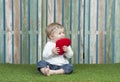 Little baby with small red heart pillow Royalty Free Stock Photo