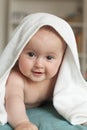 Little baby smiling, laughing.Cute baby lying on her tummy over a white towel Royalty Free Stock Photo