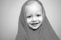 Little baby smiling under a white towel. Small little cute sweet blonde boy bathes in a bath. Royalty Free Stock Photo