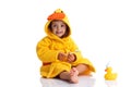 Little baby smiling under a yellow towel and brushing his teeth Royalty Free Stock Photo