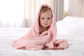 Cute little baby with soft pink towel on bed after bath Royalty Free Stock Photo