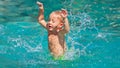 Little baby splashing with fun in beach swimming pool