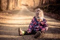 Little baby toddler sitting and playing on road in winter Royalty Free Stock Photo