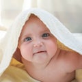 A little baby under a white towel Royalty Free Stock Photo