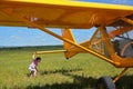 Light private plane parked on the grassy airfield and a small ch