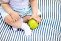 Little baby& x27;s fingers holding yellow pear Royalty Free Stock Photo